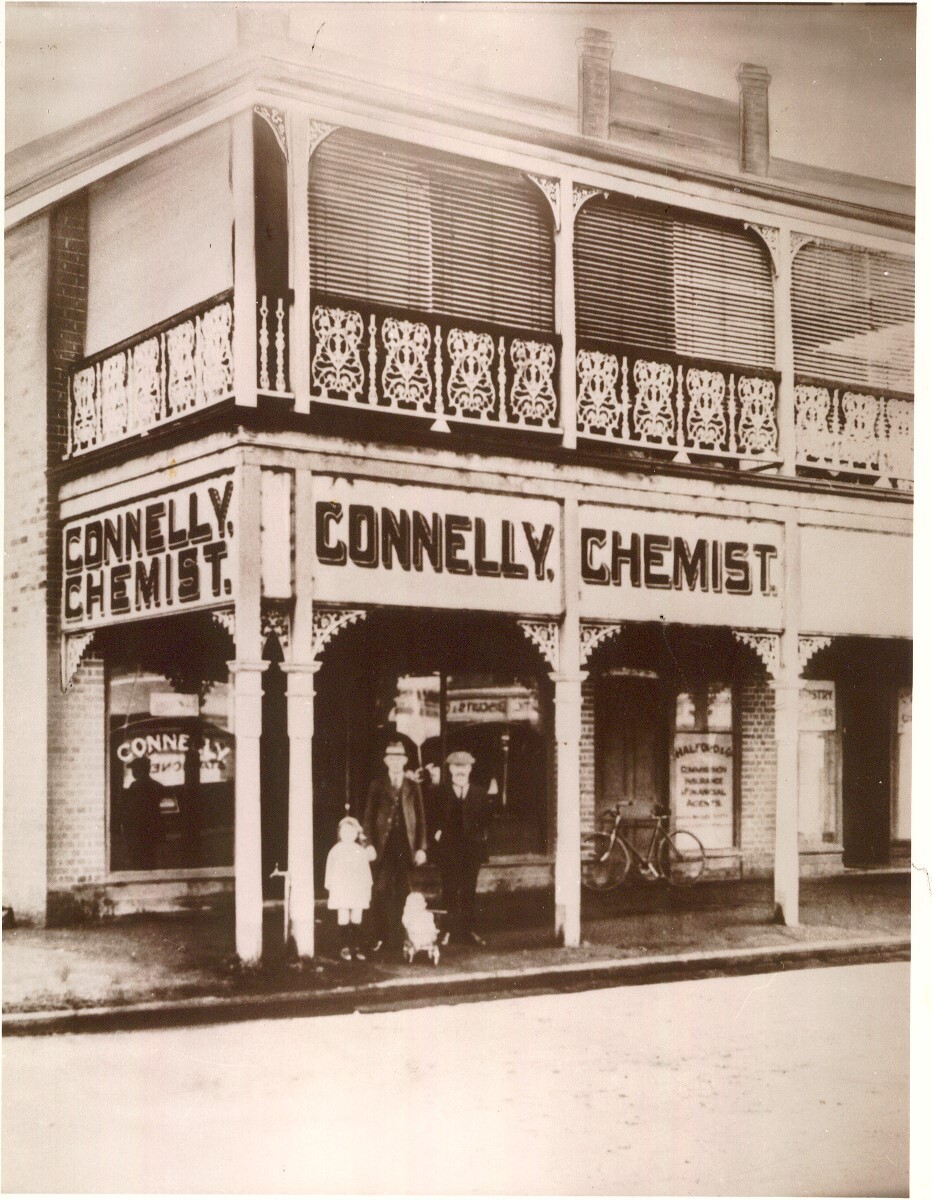 A group of people standing in front of Connelly's Pharmacy, Dalby, circa 1920s