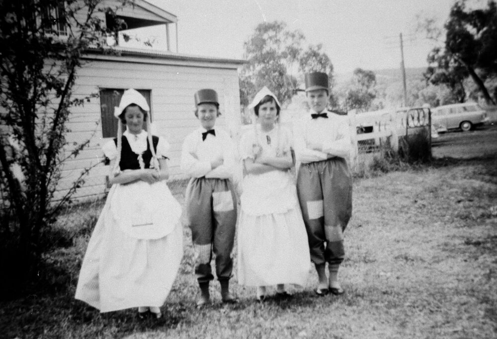 Four people in fancy dress, no location, no date