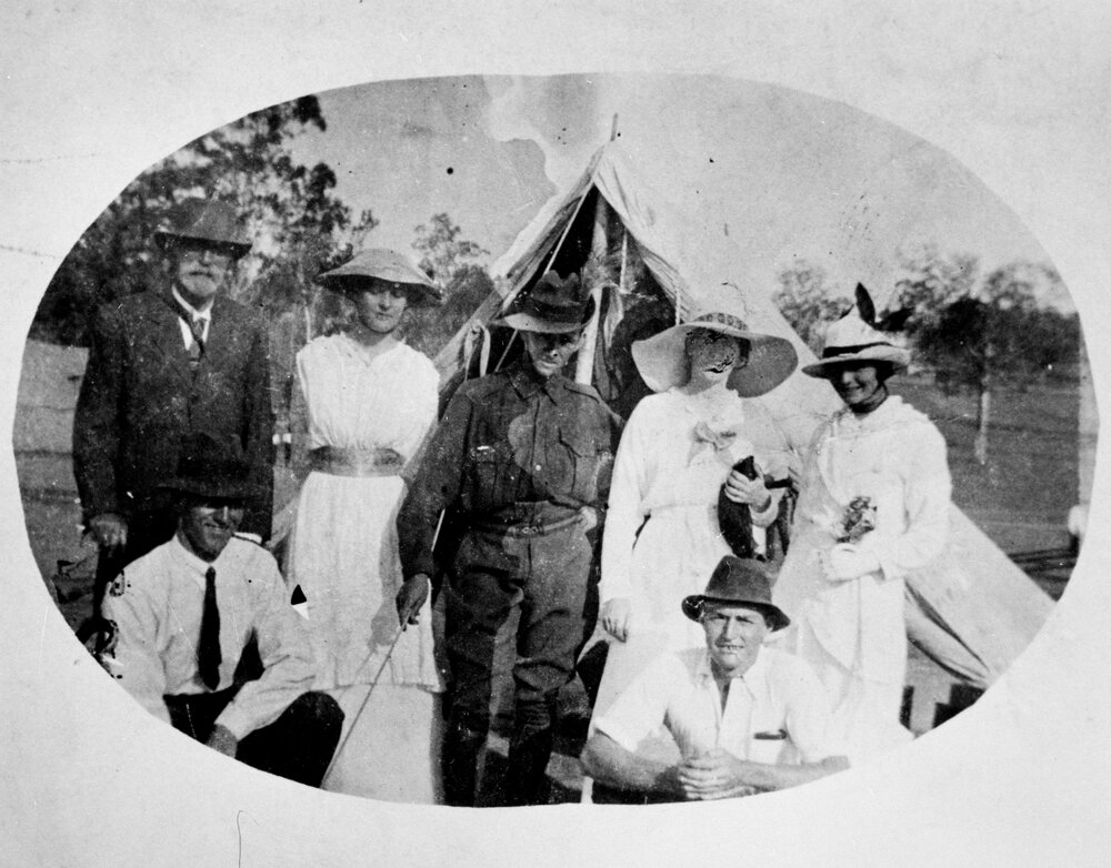 Group in front of a tent, no location, no date