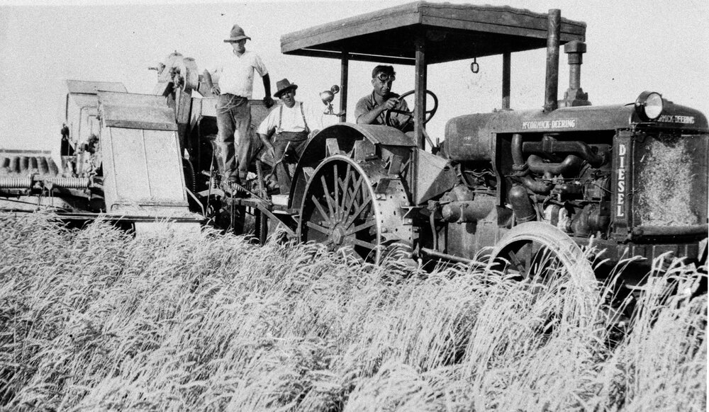 Three men on a tractor, no location, no date