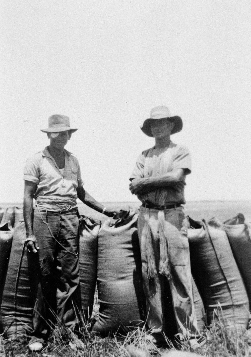 Two men with grain bags, no location, no date