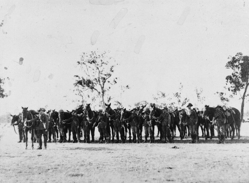 Jandowae Troop of the 11th Light Horse Regiment standing beside their horses, 1929