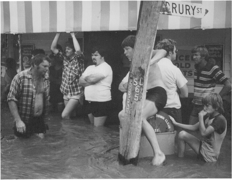 Unknown people standing in floodwaters at Geisel's Store in Dalby, 1981