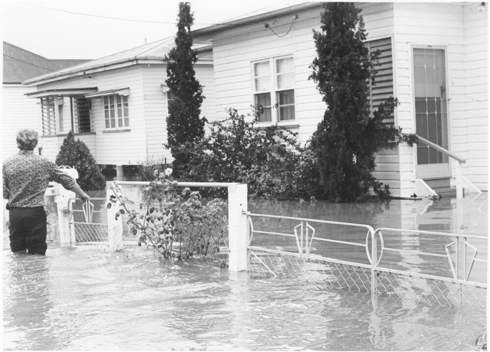 Man walking in floodwaters, Dalby, 1981