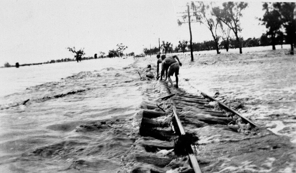 Floodwaters crossing the railway bridge, Warra, 1942