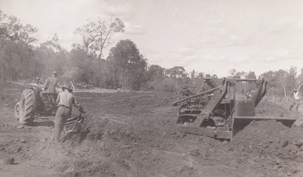 Road plough being pulled by a tractor near Guluguba, 1940