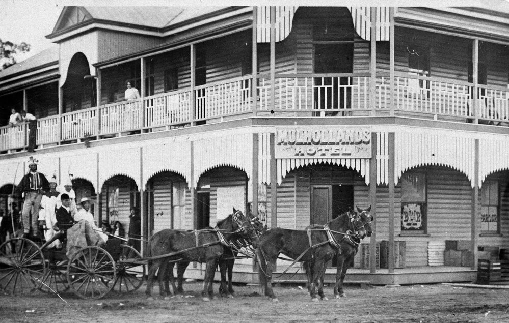 People dressed in fancy dress outfits in front of Mulholland's Hotel, Jandowae, 1913