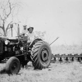 Two men on a tractor, no location, no date