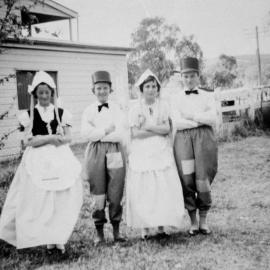 Four people in fancy dress, no location, no date