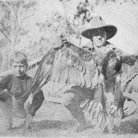 Man & boy with an eagle, no location, no date