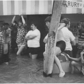 Unknown people standing in floodwaters at Geisel's Store in Dalby, 1981