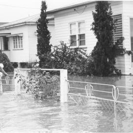 Man walking in floodwaters, Dalby, 1981