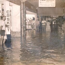 Unknown people standing in floodwaters in Cunningham Street, Dalby, 1983